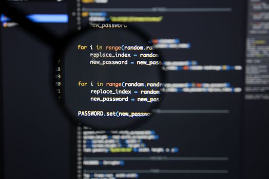 Real Python code developing screen. Programing workflow abstract algorithm concept. Lines of Python code visible under magnifying lens.
