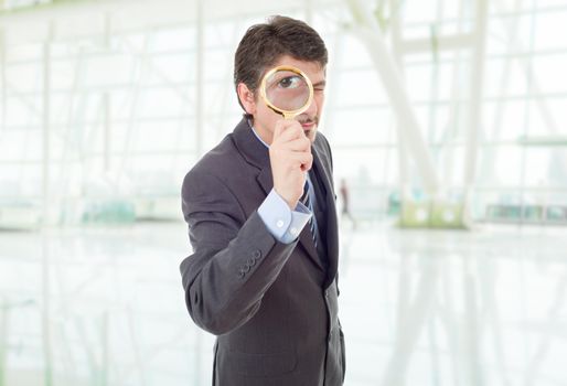 business man with magnifying glass at the office