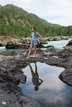 Woman resting at river in Altai Mountains territory