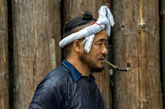 A Basha Miao Man in the Basha Miao Village of the  Congjiang county, Guizhou of China.