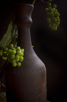 Clay bottle for wine on a black background