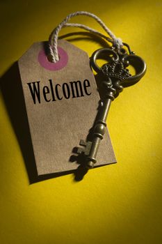 Vintage key with the label and the word welcome