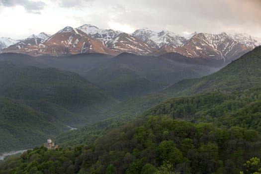 Church of the 10 century between mountains covered with forest, Russia, Caucasus.