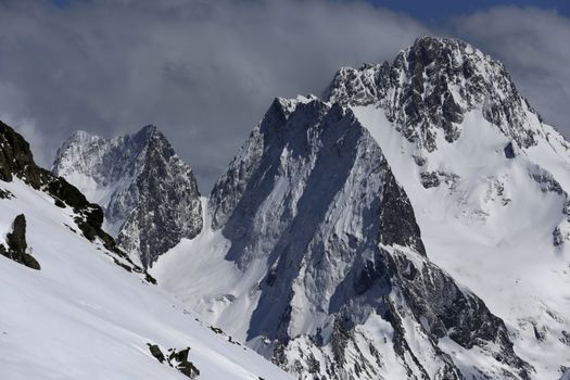 View of Snow Mountain Range Landscape with Blue Sky. Russia, Caucasus.