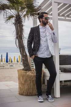 Elegant Boy smokes at a cocktail party