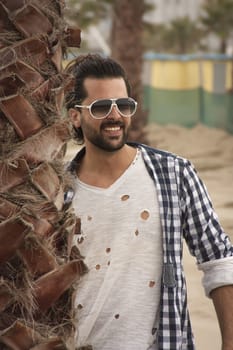 Portrait of a smiling boy in casual clothes with sunglasses