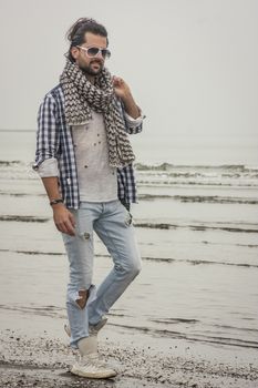 Fashion boy posing for a shooting at beach
