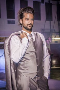 Boy parades in a groom's suit for a event