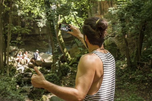 Selfie moment: boy taking a selfie during a trip