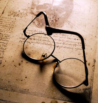 Close up of old classic spectacles on a book background