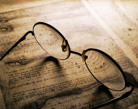 Close up of old classic spectacles on a book background