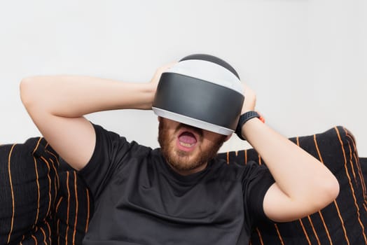 Bearded man wearing virtual reality goggles