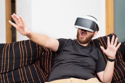 Bearded man wearing virtual reality goggles