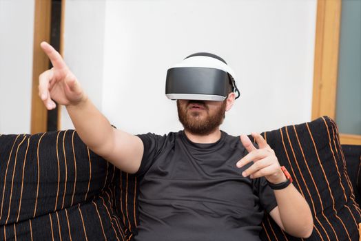 Bearded man wearing virtual reality goggles