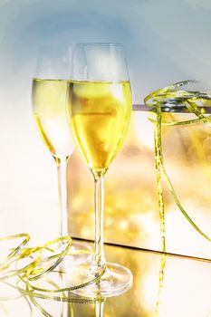 Two glasses of wine and a box with a ribbon on white background