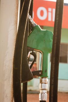 Fuel oil gasoline dispenser at petrol filling station.Holding fuel nozzle to refuel gasoline for car
