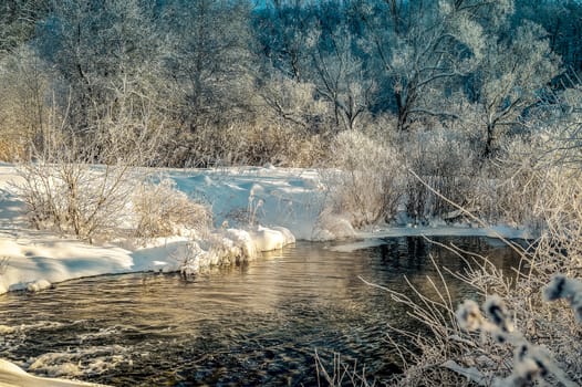 Winter sunny landscape with river and forest.