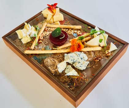 Cheese selection on wooden rustic board. Cheese platter with different cheeses on wood