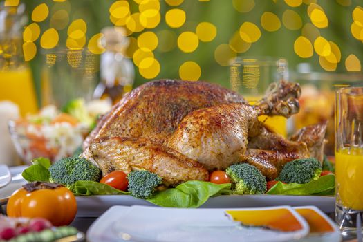 Celebrating Thanksgiving with roasted turkey on festive table. Roasted turkey on festive table for Thanksgiving celebration