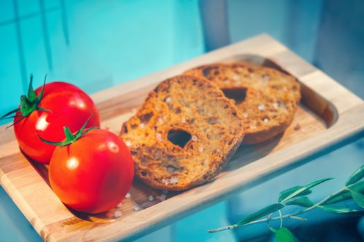 italian food gastronomy hard ring of bread from Puglia regional product called Friselle or Bruschetta or Pane e Pomodoro .