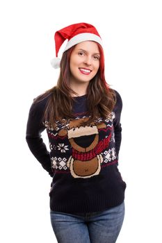 Beautiful young smiling girl wearing a Christmas hat and sweater, isolated on white background.