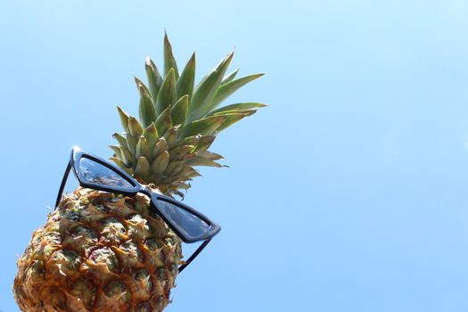 The picture shows a funny pineapple with sunglasses.