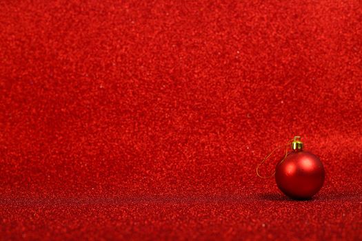 Christmas or new year decor of bauble on abstract red light background
