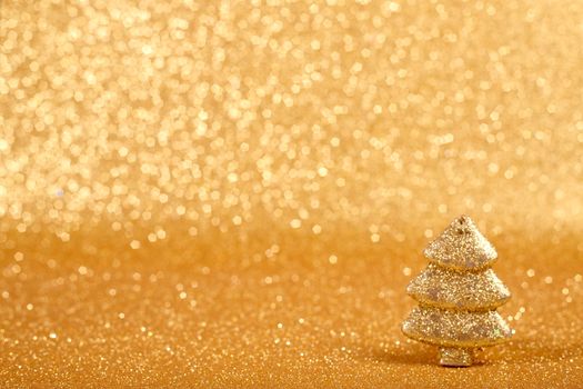 Golden christmas fir tree decoration on glitter background