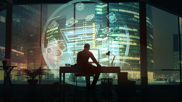 Opposite the large skyscrapers of the business center, a web designer works looking in a virtual holographic interface.