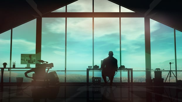 In a film studio with large windows, a silhouette of a man working at the desk.