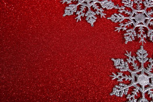 Christmas or new year decor of silver snowflakes on abstract red light background