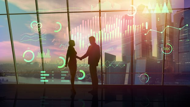 A scene of a handshake of a man and woman silhouettes against the background of a window and a glowing virtual infographic.