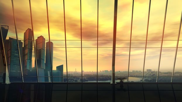 Large panoramic window in the modern office with a view of the skyscrapers at sunset.