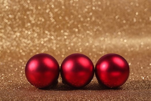 Christmas balls on abstract gold glitters bokeh background