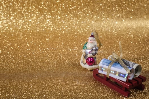 Christmas money gift on abstract gold glitters bokeh background