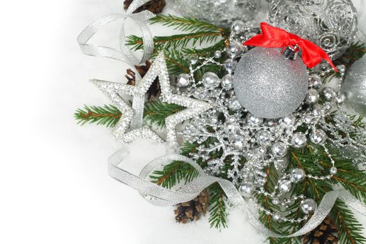 Christmas card with silver baubles and gifts on snow background with copyspace