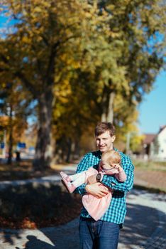 Happy loving family. Father and his daughter child girl playing and hugging outdoors. Cute little girl hugs daddy. Concept of Father's day. Authentic image.