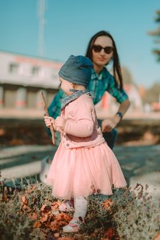 Adorable girl having fun on beautiful autumn day. authentic childhood image