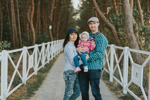 Happy loving family. Father and his daughter child girl playing and hugging outdoors. Cute little girl hugs daddy. Concept of Father's day. Authentic image.