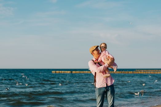 Happy loving family. Father and his daughter child girl playing and hugging outdoors. Cute little girl hugs daddy. Concept of Father's day. Authentic image.