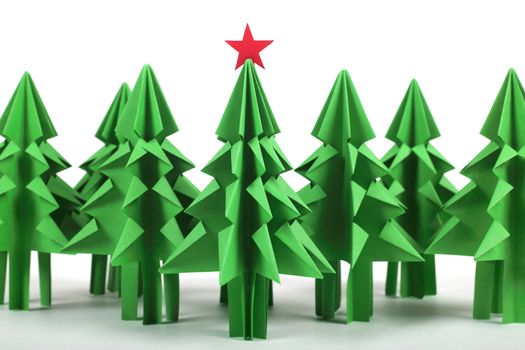 Origami Christmas trees of green craft paper isolated on white background