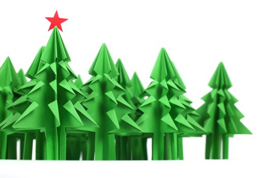 Origami Christmas trees of green craft paper isolated on white background