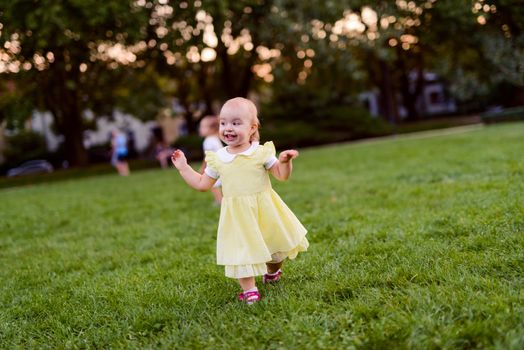 Smiling girl on the meadow looking right at camera. authentic image