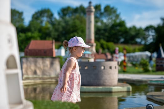 Little girl spending fantastic time on playground. Happy childhood. Authentic image