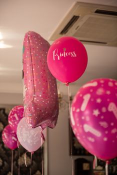 Baby girl 1 year old party rooms with balloons. Birthday party. Childhood.
