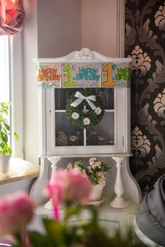 Baby girl 1 year old decorations in room. Birthday party. Authentic childhood image.