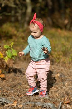 Adorable girl having fun on beautiful autumn day. authentic childhood image