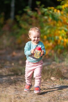 Adorable girl having fun on beautiful autumn day. authentic childhood image