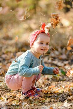 Adorable girl having fun on beautiful autumn day. authentic childhood image