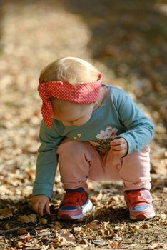 Adorable girl having fun on beautiful autumn day. authentic childhood image